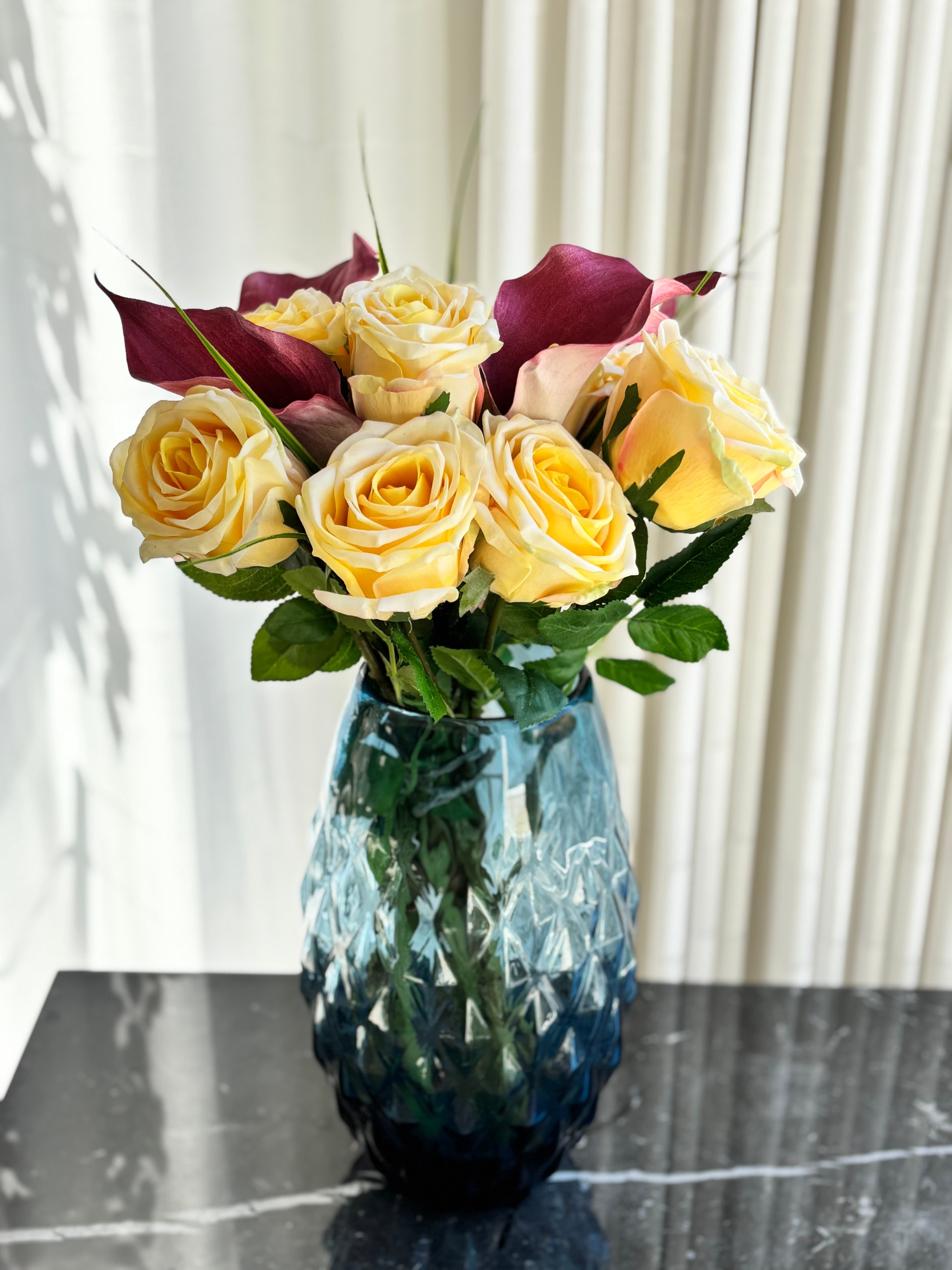 Kunstig buket med gule roser og røde liljer